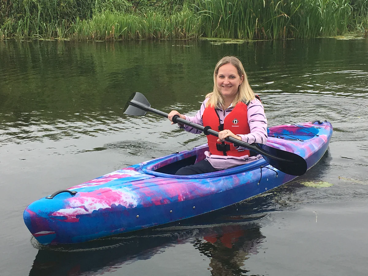 BLUE/PINK girl kayaking in the river nene in peterborough on a riber sit in kayak